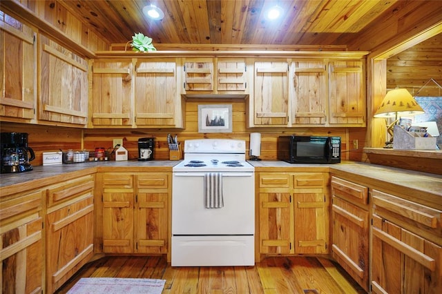 66 Lost Oaks Trl, Broken Bow, OK 74728 - kitchen featuring white range with electric cooktop, black microwave, wooden ceiling, wooden walls, and light wood finished floors