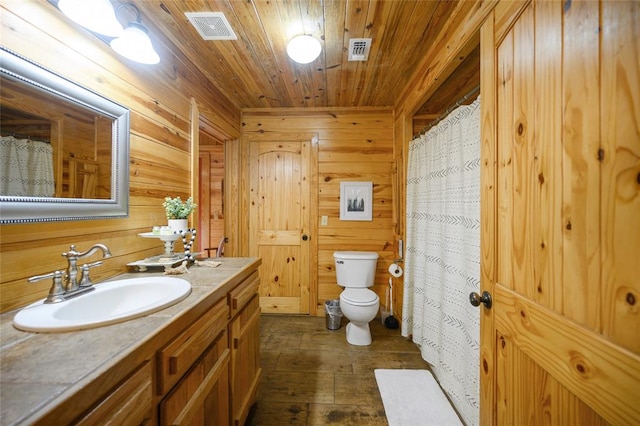 bathroom with wooden ceiling, wood-type flooring, toilet, wooden walls, and vanity