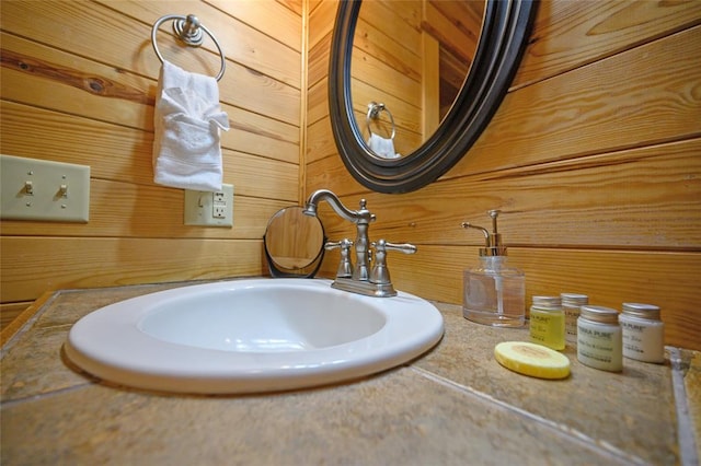 bathroom with wood walls and sink