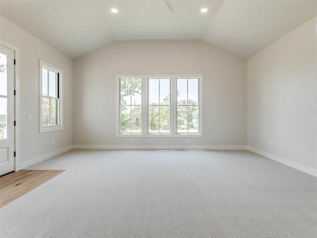 unfurnished room featuring ceiling fan, light carpet, and vaulted ceiling