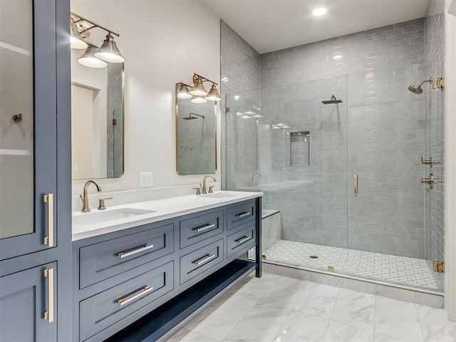 bathroom featuring vanity and a shower with door