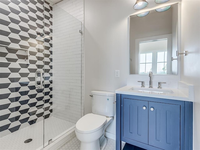 bathroom with tile patterned flooring, vanity, toilet, and an enclosed shower