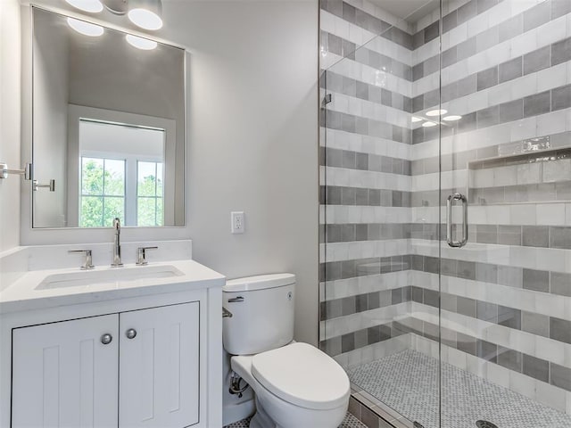 bathroom with vanity, toilet, and an enclosed shower