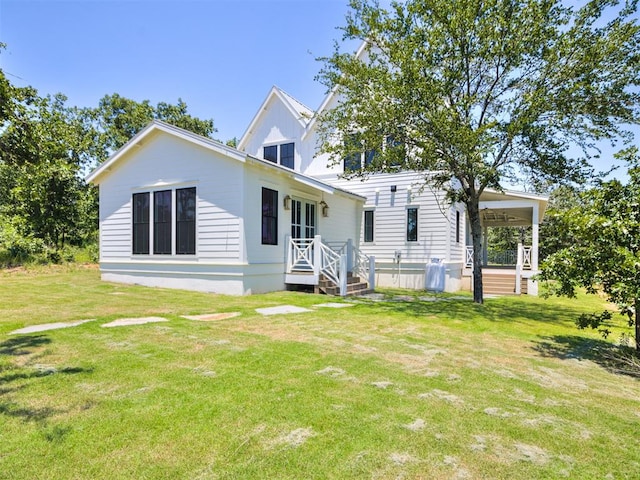 back of house with a lawn