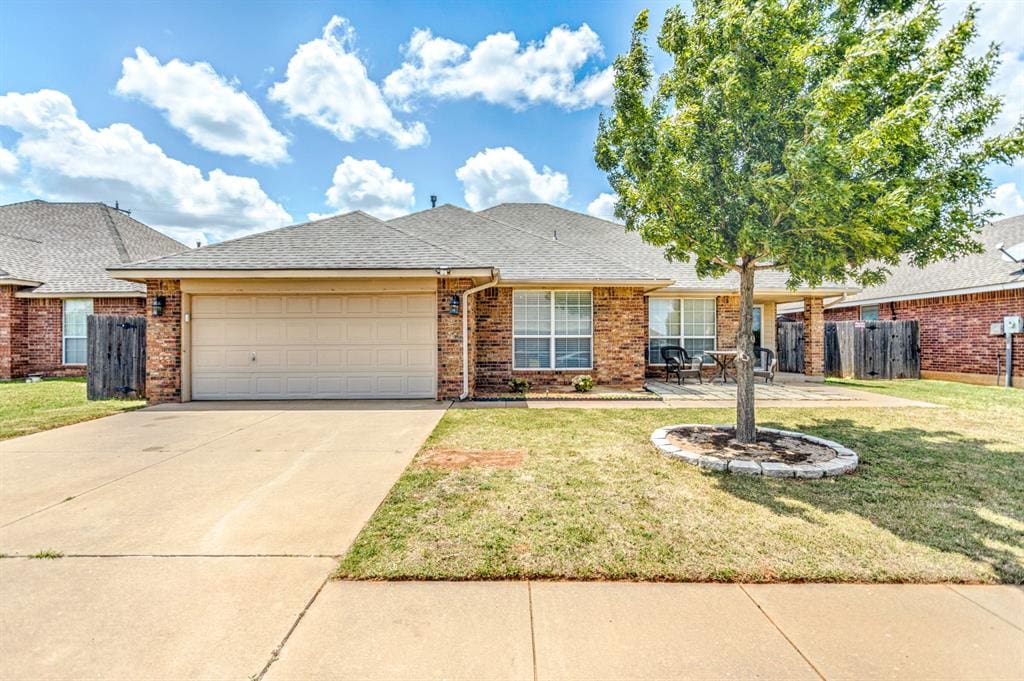 ranch-style home featuring a front yard and a garage