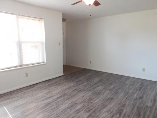 spare room featuring dark hardwood / wood-style floors and ceiling fan