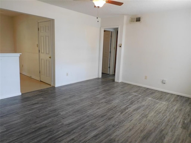 unfurnished room with ceiling fan and dark wood-type flooring