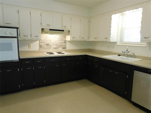 kitchen featuring white cabinetry, range hood, white appliances, and sink