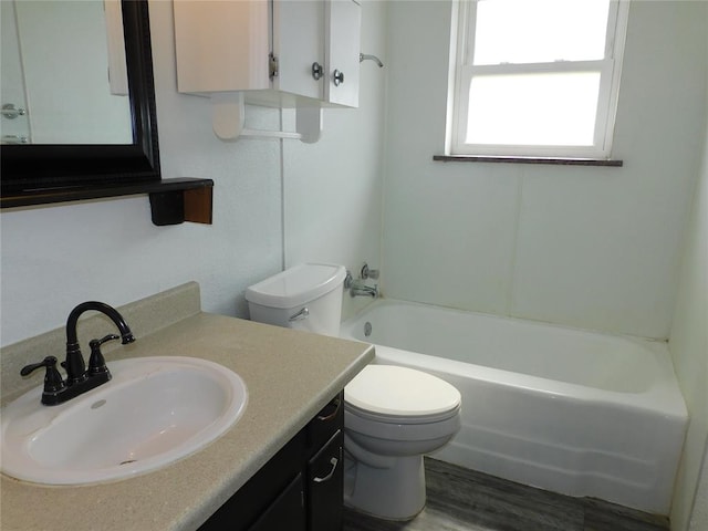 bathroom with hardwood / wood-style floors, vanity, and toilet