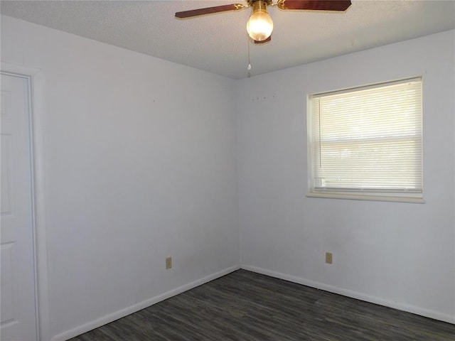 empty room featuring a textured ceiling, dark hardwood / wood-style flooring, and ceiling fan