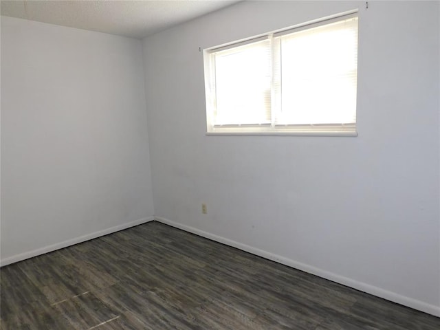 spare room featuring dark hardwood / wood-style flooring