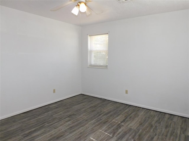 spare room with ceiling fan and dark hardwood / wood-style floors