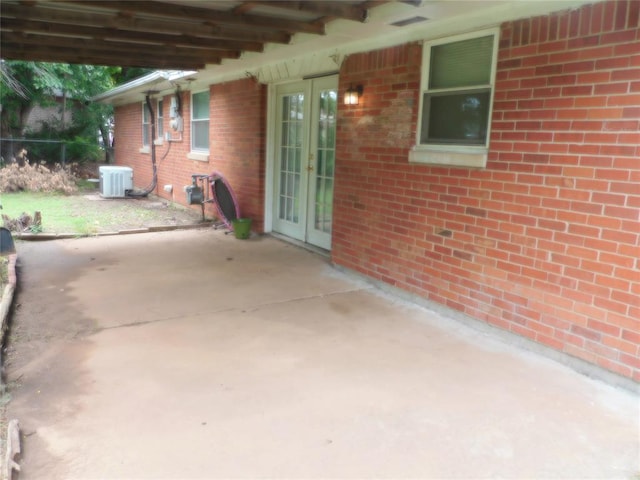 view of patio / terrace with french doors and central AC unit