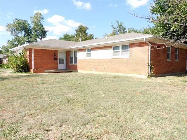 back of house with a lawn