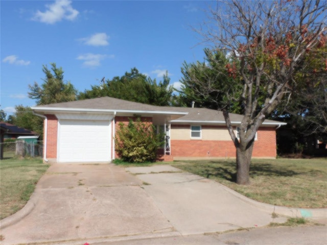 ranch-style home featuring a garage and a front lawn