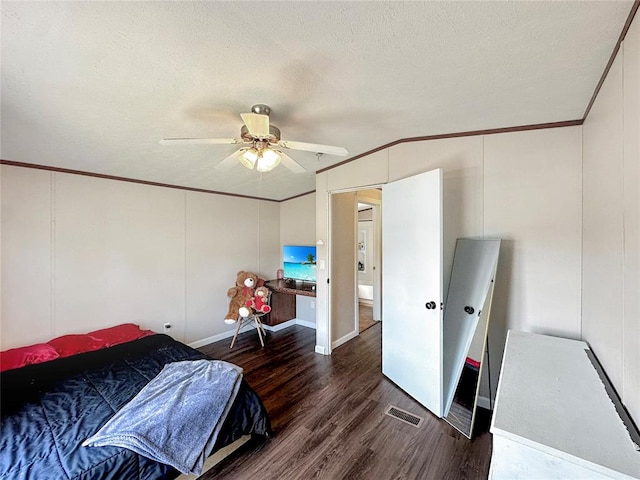 bedroom with a textured ceiling, dark hardwood / wood-style floors, ceiling fan, and crown molding