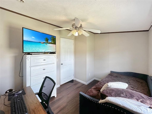 home office with dark hardwood / wood-style floors, ceiling fan, ornamental molding, and a textured ceiling