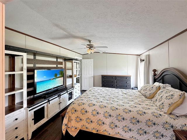 bedroom featuring a textured ceiling, dark hardwood / wood-style floors, ceiling fan, and ornamental molding