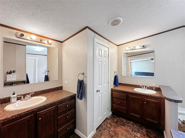 bathroom featuring vanity, a textured ceiling, and crown molding