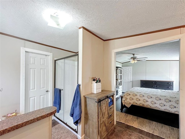 bedroom featuring ceiling fan, ornamental molding, and a textured ceiling