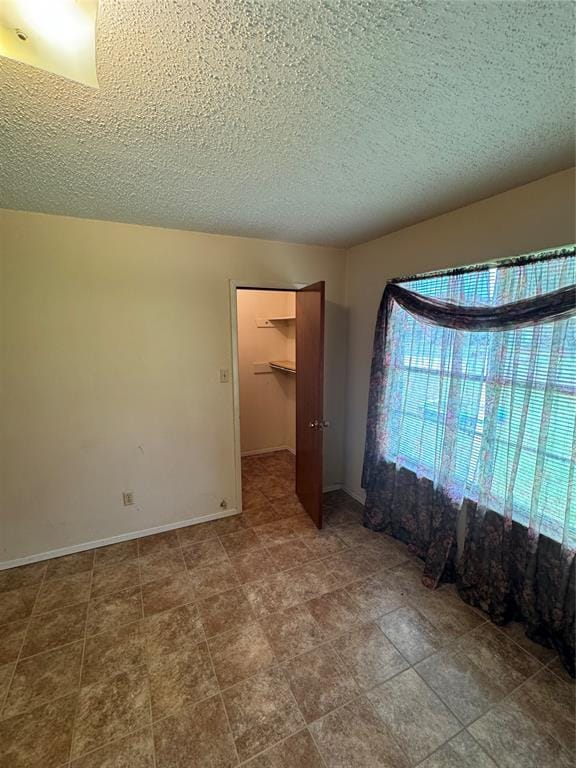 spare room with a textured ceiling