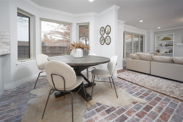 dining area featuring a wealth of natural light, built in features, and ornamental molding