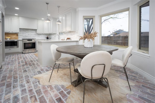 dining room featuring crown molding