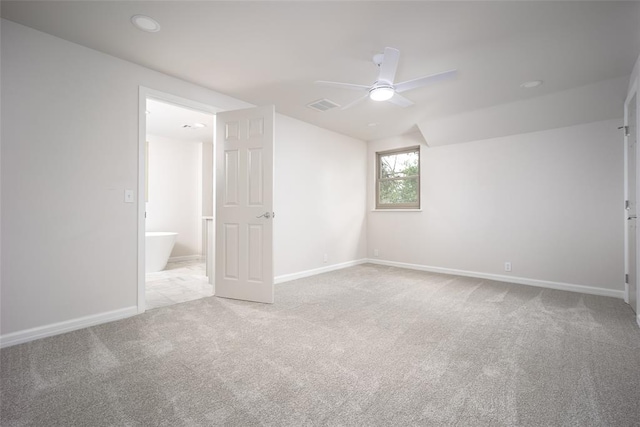 carpeted spare room featuring ceiling fan