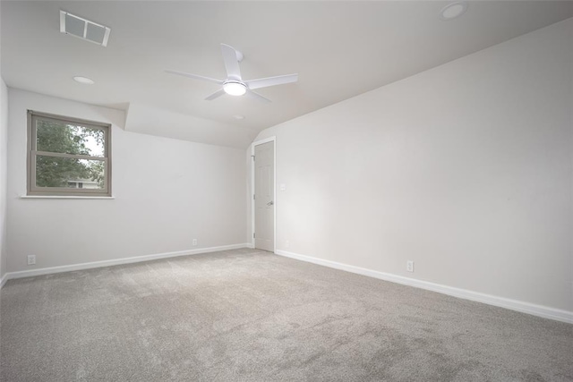 unfurnished room with lofted ceiling, ceiling fan, and carpet floors