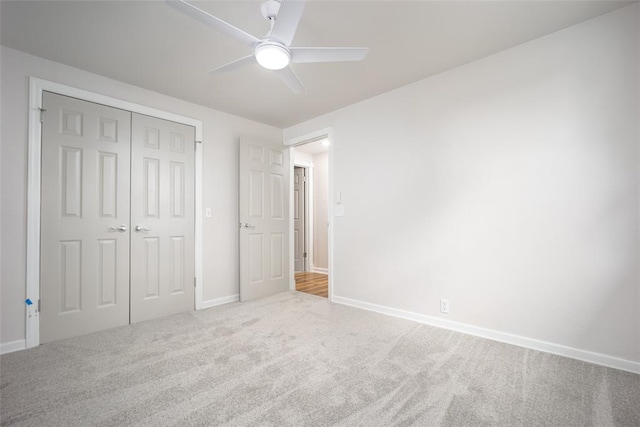 unfurnished bedroom with ceiling fan, a closet, and carpet floors