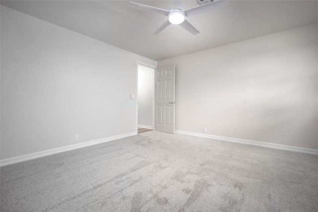 spare room featuring ceiling fan and carpet floors