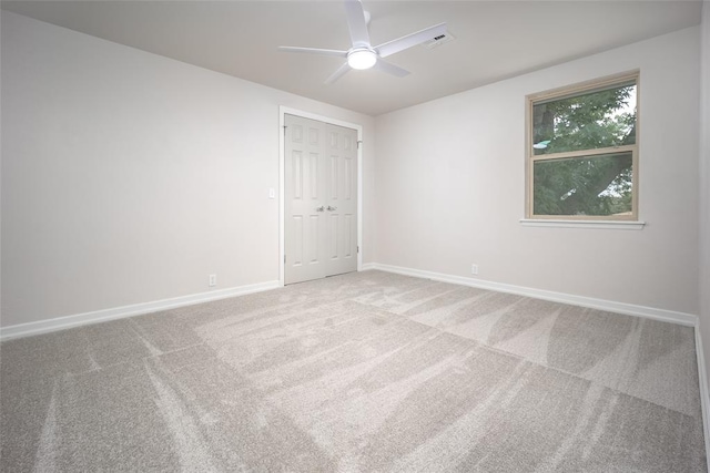 carpeted empty room featuring ceiling fan