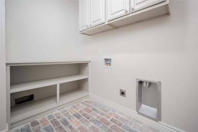 clothes washing area with electric dryer hookup, cabinets, and washer hookup