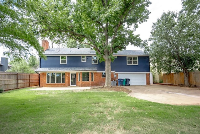 rear view of property with a lawn, a garage, and central air condition unit