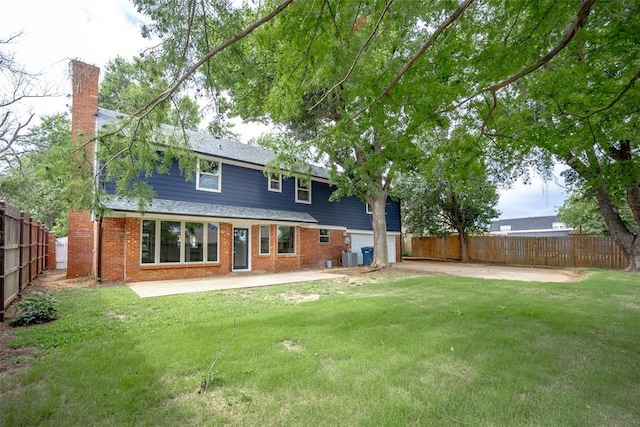 rear view of property featuring a lawn, a patio area, and central air condition unit