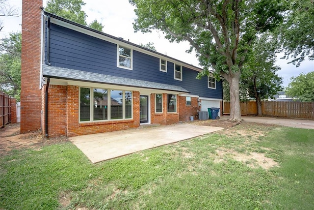 back of house with a yard, cooling unit, and a patio