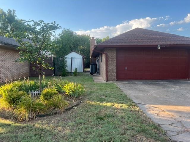 view of property exterior with a yard, a garage, and cooling unit