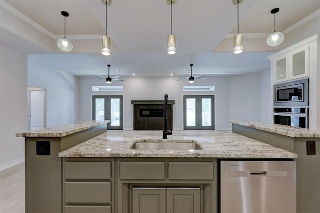 kitchen with a healthy amount of sunlight, sink, appliances with stainless steel finishes, and french doors