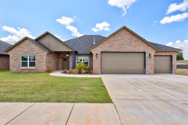 view of front of house featuring a front yard and a garage