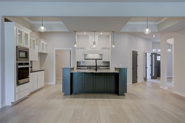 kitchen featuring pendant lighting, stainless steel appliances, white cabinetry, and light stone counters