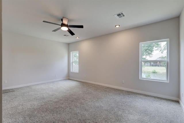 spare room featuring carpet flooring and ceiling fan