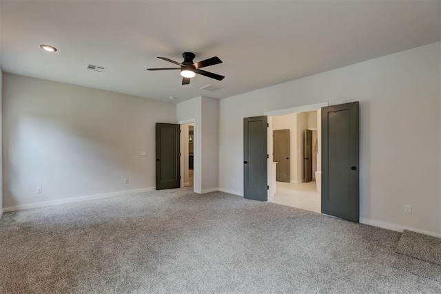 unfurnished bedroom with light colored carpet and ceiling fan