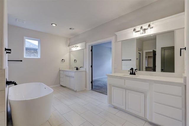 bathroom with vanity and a bathtub