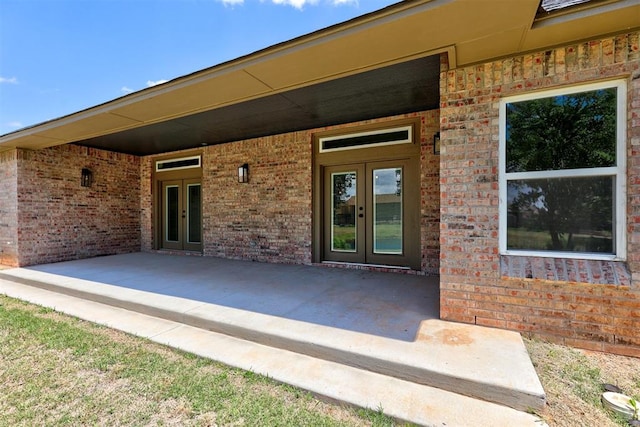 property entrance featuring french doors and a patio