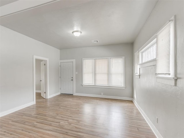 spare room with light hardwood / wood-style flooring