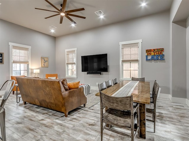 living room featuring ceiling fan and light hardwood / wood-style flooring