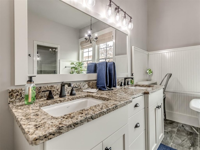 bathroom with a chandelier, vanity, and an enclosed shower