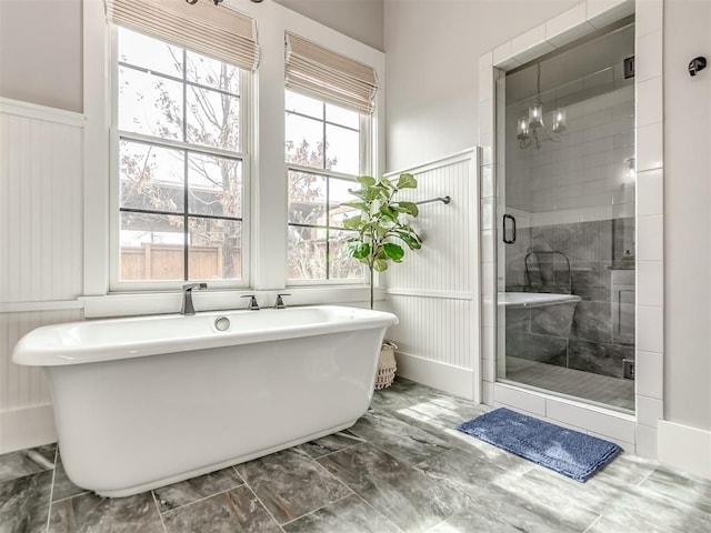 bathroom with plus walk in shower and a chandelier