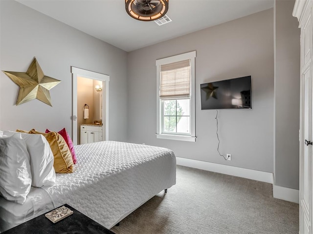 bedroom featuring dark carpet and connected bathroom