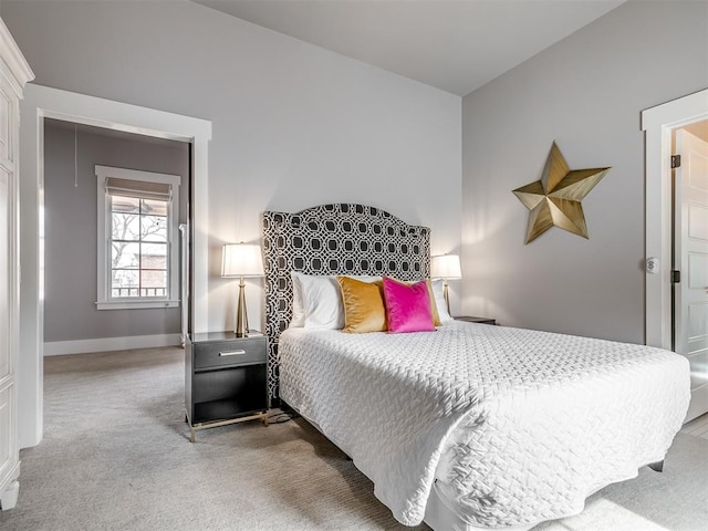 bedroom featuring light carpet